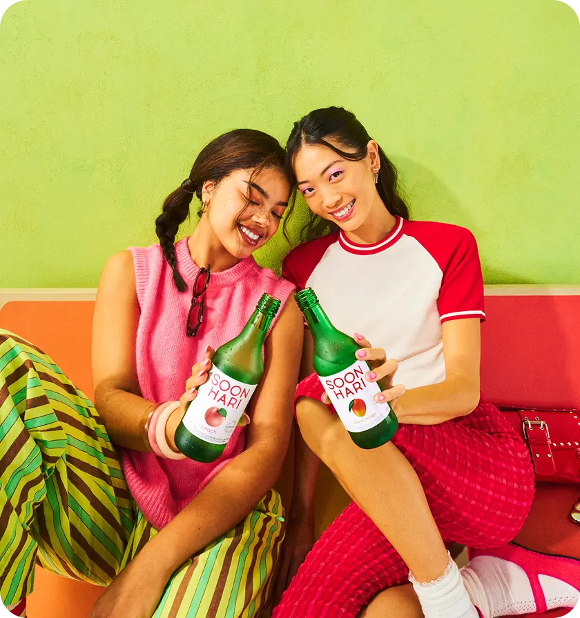 2 girls holding a Soonhari Peach and a Soonhari Apple Mango